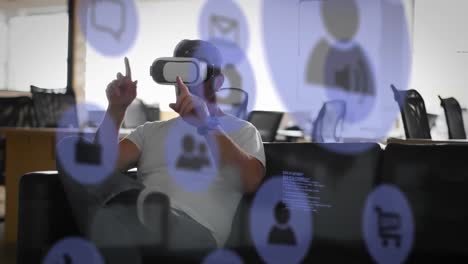 Animation-of-data-processing-and-social-media-icons-over-caucasian-man-wearing-vr-headset