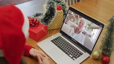 Caucasian-woman-on-video-call-with-grandmother-at-christmas-time