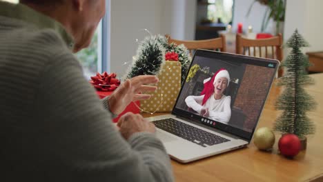 Caucasian-senior-man-on-video-call-with-adult-daughter-at-christmas-time