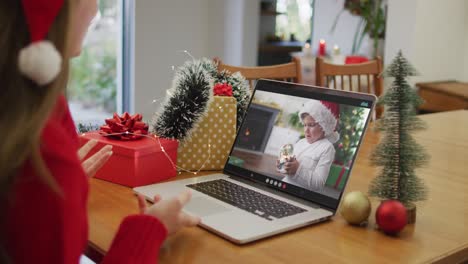 Happy-caucasian-woman-on-video-call-with-son-at-christmas-time