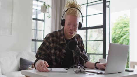 Happy-albino-african-american-man-with-dreadlocks-making-podcast