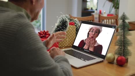 Happy-caucasian-senior-man-on-video-call-with-adult-daughter-at-christmas-time