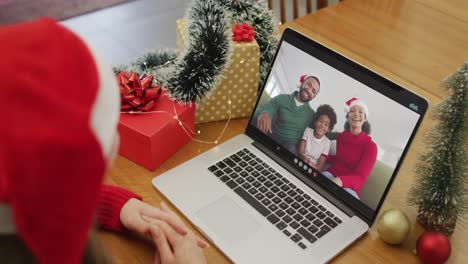 Happy-caucasian-woman-on-video-call-with-family-at-christmas-time