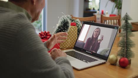 Caucasian-senior-man-on-video-call-with-senior-female-friend-at-christmas-time