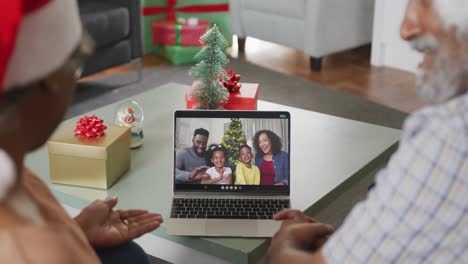 Happy-african-american-senior-couple-on-video-call-with-family-at-christmas