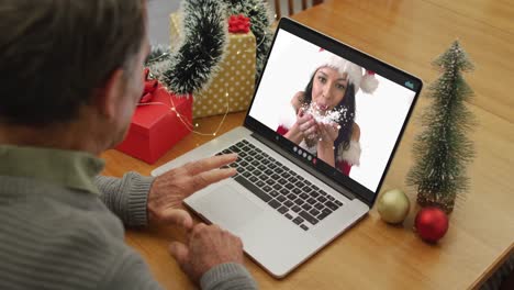 Happy-caucasian-senior-man-on-video-call-with-female-friend-at-christmas-time