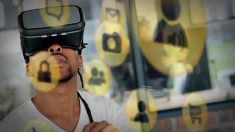 Animation-of-social-media-icons-and-data-processing-over-african-american-man-wearing-vr-headset