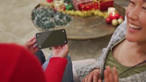 Happy-diverse-female-friends-making-christmas-smartphone-video-call,-copy-space-on-screen