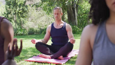 Caucasian-man-meditating-and-practicing-yoga-at-the-park