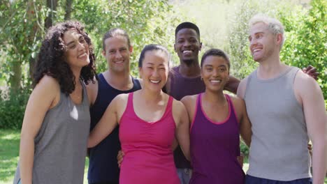 Portrait-of-group-of-diverse-young-people-smiling-while-standing-together-at-the-park