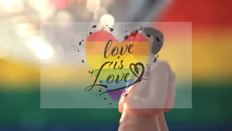 Animation-of-rainbow-heart,-love-is-love-over-rotating-gay-couple-figure
