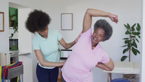 Glückliche-Afroamerikanische-Physiotherapeutin-Hilft-älteren-Patientinnen-Beim-Training-Zu-Hause