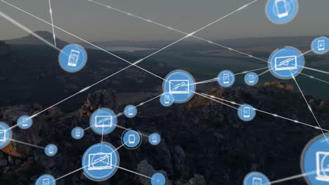 Animation-of-network-of-connections-with-icons-over-landscape