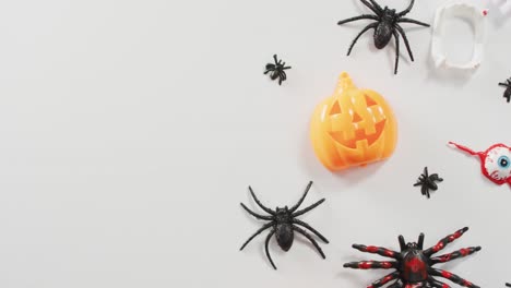 Close-up-of-multiple-halloween-toys-and-candies-with-copy-space-on-white-background