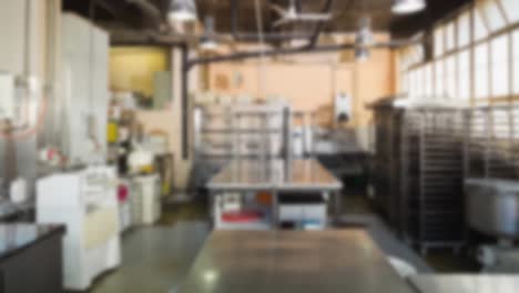 Animation-of-blurred-interior-of-empty-kitchen-in-restaurant