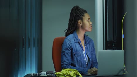 Afroamerikanische-Computertechnikerin,-Die-Einen-Laptop-Verwendet-Und-Im-Serverraum-Eines-Unternehmens-Arbeitet