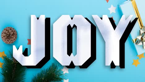 Animation-of-joy-christmas-text-over-decorations-on-blue-background