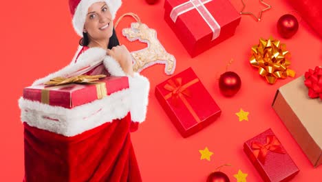 Composition-of-caucasian-woman-in-santa-hat-holding-christmas-presents-on-red-background
