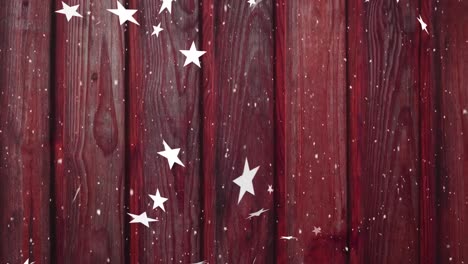 Animation-of-christmas-stars-falling-over-burgundy-wooden-background