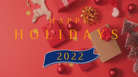 Animation-Von-Frohen-Feiertagen,-Weihnachtstext-über-Dekorationen-Auf-Rotem-Hintergrund