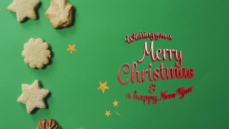 Animation-Des-Textes-„Frohe-Weihnachten“-über-Keksen-Auf-Grünem-Hintergrund