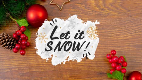 Animation-of-let-it-snow-christmas-text-and-decorations-on-wooden-background