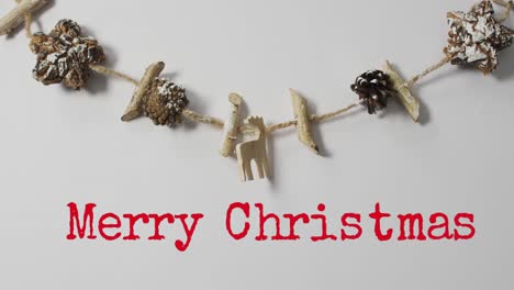 Animation-of-merry-christmas-greetings-text-over-christmas-decorations