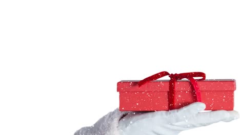 Animation-Von-Schnee,-Der-über-Den-Weihnachtsmann-Fällt,-Der-Ein-Geschenk-Hält