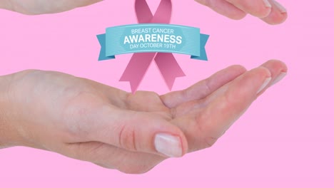 Animation-of-breast-cancer-awareness-day-text-with-ribbon-logo-over-hands-of-woman,-on-pink