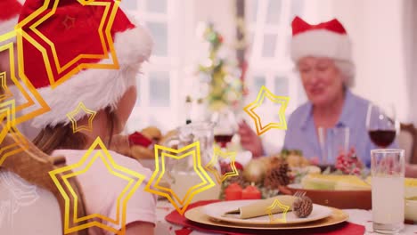 Animation-of-stars-falling-over-happy-caucasian-family-wearing-santa-hats-and-having-dinner