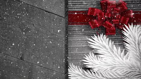 Animation-of-snow-falling-at-christmas-over-red-ribbon