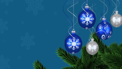 Animation-of-christmas-baubles-over-snow-falling