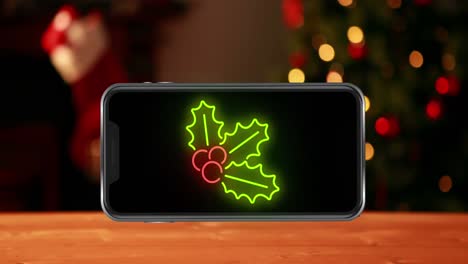 Animation-of-leaves-on-smartphone-over-christmas-tree