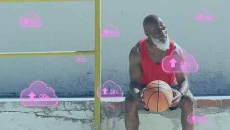Animation-of-clouds-with-percentage-over-senior-african-american-man-with-basketball-at-beach