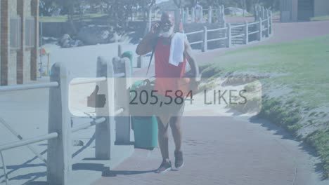 Animation-of-media-icon-over-senior-african-american-man-using-smartphone-at-beach