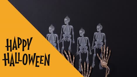 Animation-of-happy-halloween-text-over-skeletons