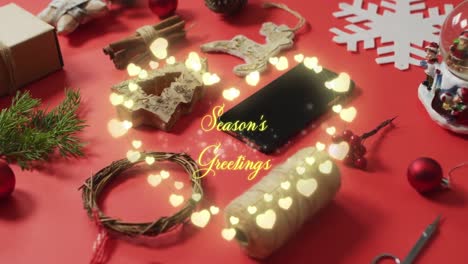 Animation-of-seasons-greetings-text-over-christmas-decorations