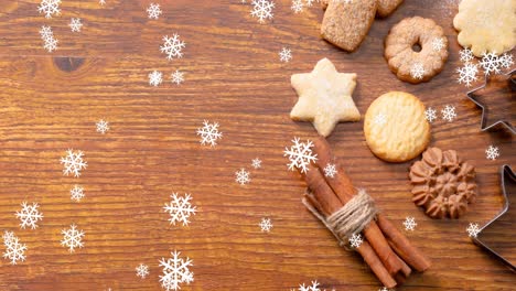 Animation-of-snow-falling-over-christmas-cookies-on-table