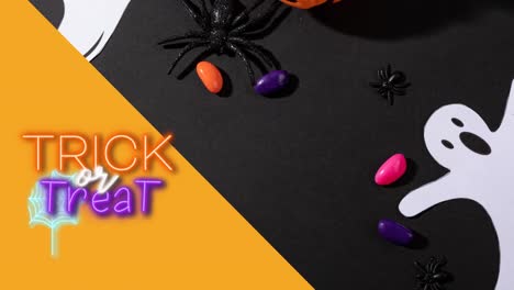 Animation-of-trick-or-treat-text-over-sweets