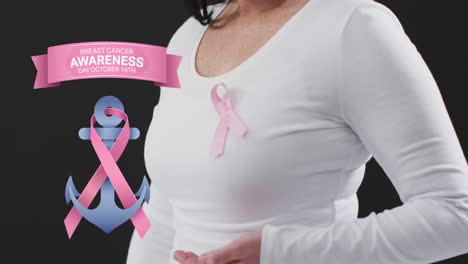 Breast-cancer-awareness-text-banner-against-mid-section-of-woman-wearing-pink-ribbon-on-her-chest
