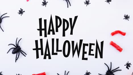 Animation-of-happy-halloween-text-over-spiders