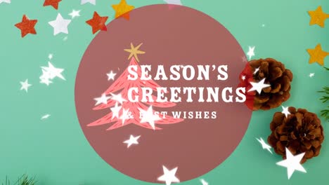 Animation-of-season's-greetings-text-over-stars-falling,-christmas-decoration-on-table