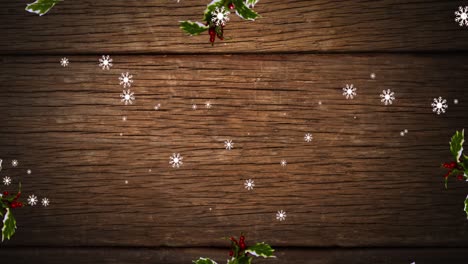 Animation-of-snow-falling-over-leaves-and-wooden-background-at-christmas