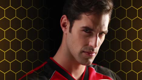 Animation-of-hexagonal-grid-and-light-over-portrait-of-caucasian-male-soccer-player