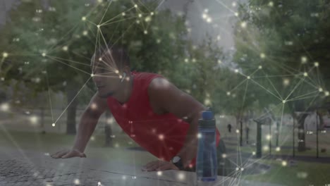 Animation-of-glowing-communication-network-moving-over-male-athlete-exercising-outdoors