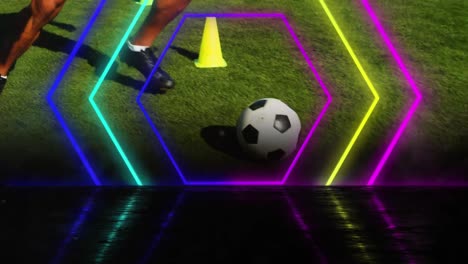 Animation-of-colourful-neon-hexagons-over-football-player-training-with-ball
