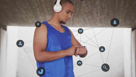 Animation-of-network-media-icons-over-male-athlete-exercising-using-smartwatch-and-headphones
