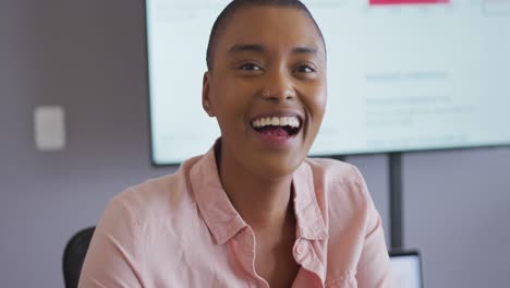 Portrait-of-smiling-african-american-businesswoman-laughing-in-meeting-room