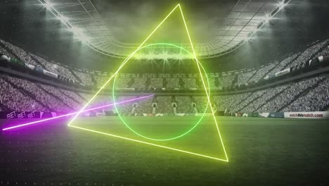 Animation-of-rotating-neon-shapes-and-lights-over-floodlit-sports-stadium
