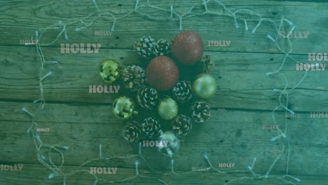 Animation-of-holly-text-in-white,-on-green-over-christmas-decorations-and-fairy-lights